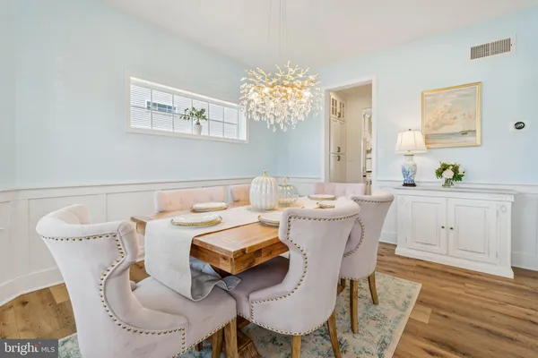 a view of a dining room with furniture and chandelier