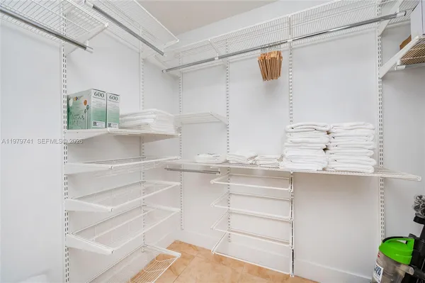 a view of walk in closet and window