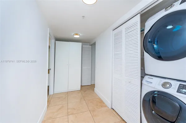 a view of a hallway with washer and dryer