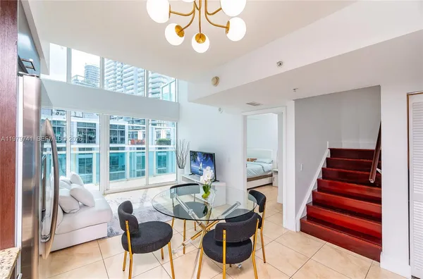 a view of a livingroom with furniture a front door and wooden floor
