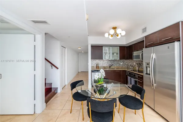 a kitchen with furniture and a refrigerator