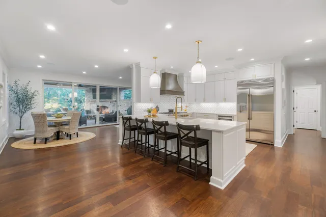 a spacious bathroom with a double vanity sink a bathtub and mirror