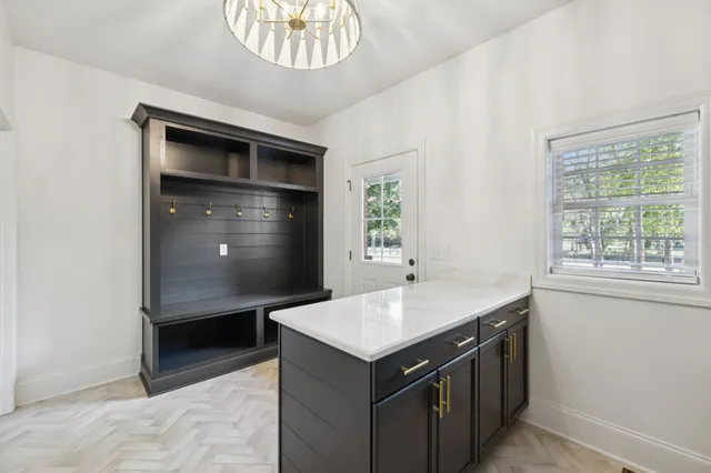 a bedroom with furniture and a large window