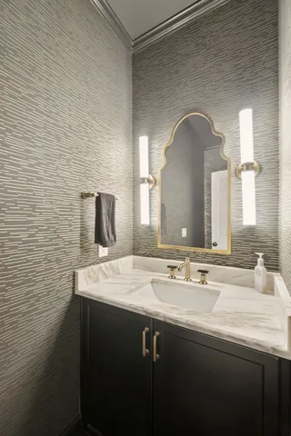 a spacious bedroom with a bed and a chandelier