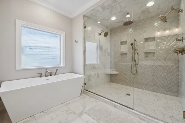 a view of a patio with table and chairs near a barbeque