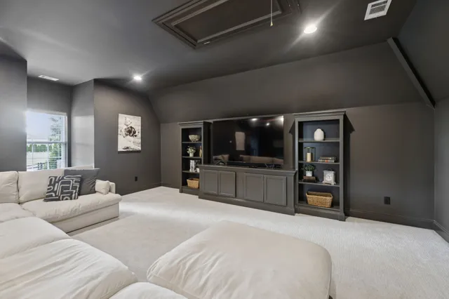 a living room with furniture a flat screen tv and a fireplace