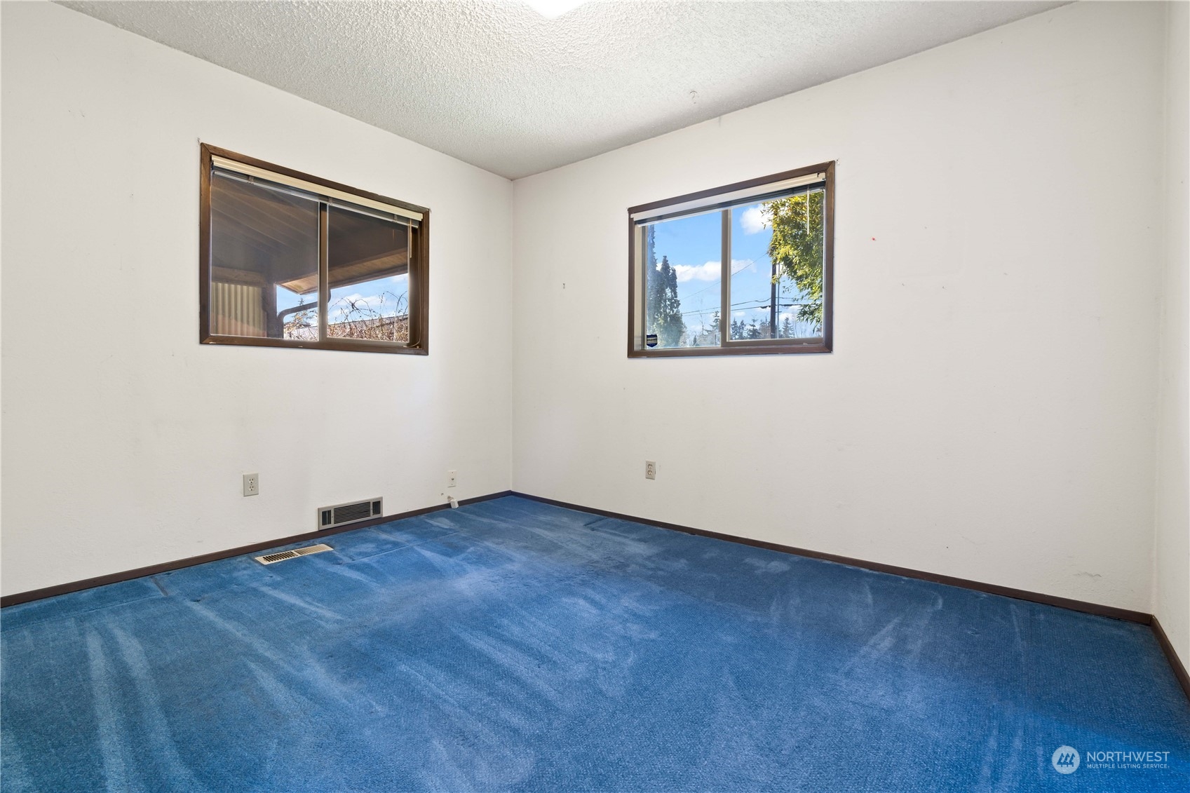 11801 Silver Way Everett, WA 98208 - Photo 15 of 32 an empty room with wooden floor and windows