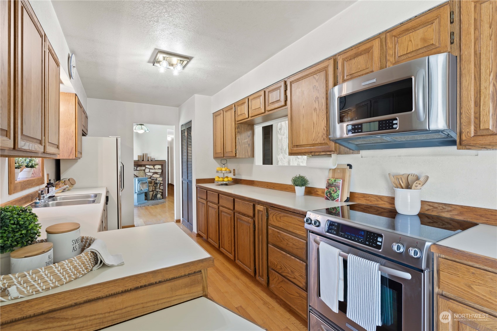 11801 Silver Way Everett, WA 98208 - Photo 8 of 32 a kitchen with stainless steel appliances a stove microwave and sink