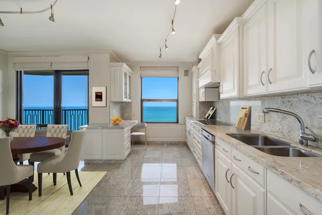 a kitchen with stainless steel appliances granite countertop a sink and cabinets