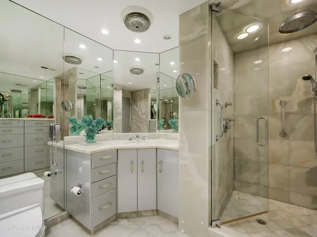 a bathroom with a double vanity sink mirror and shower