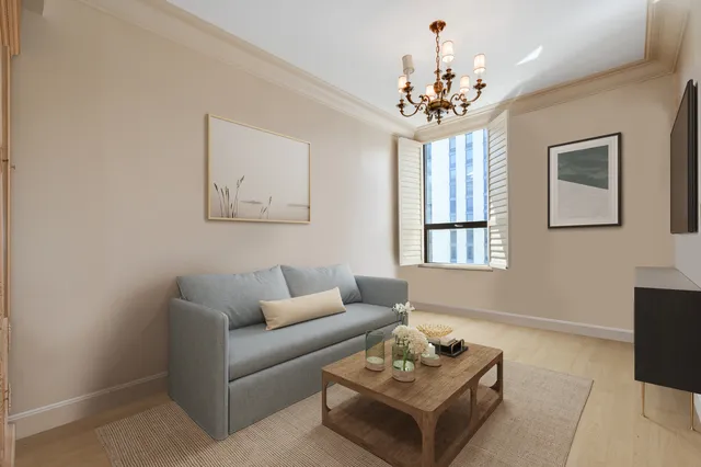 a living room with furniture a chandelier and a window