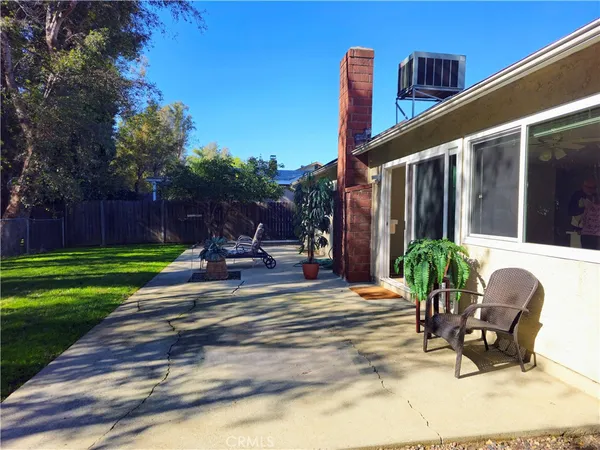 a view of a backyard with sitting area furniture and garden