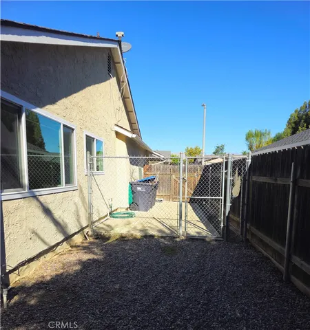 a view of a terrace with chairs and wooden fence