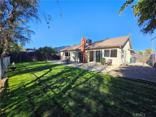 a front view of a house with a yard table and chairs