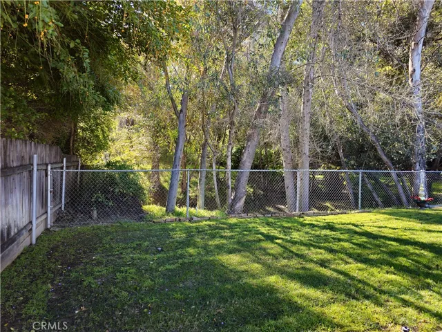 a view of a park with large trees