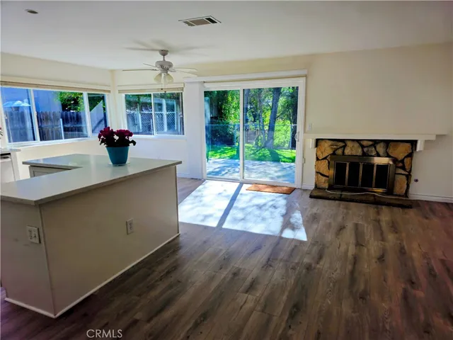 a living room with hardwood floor and a large window