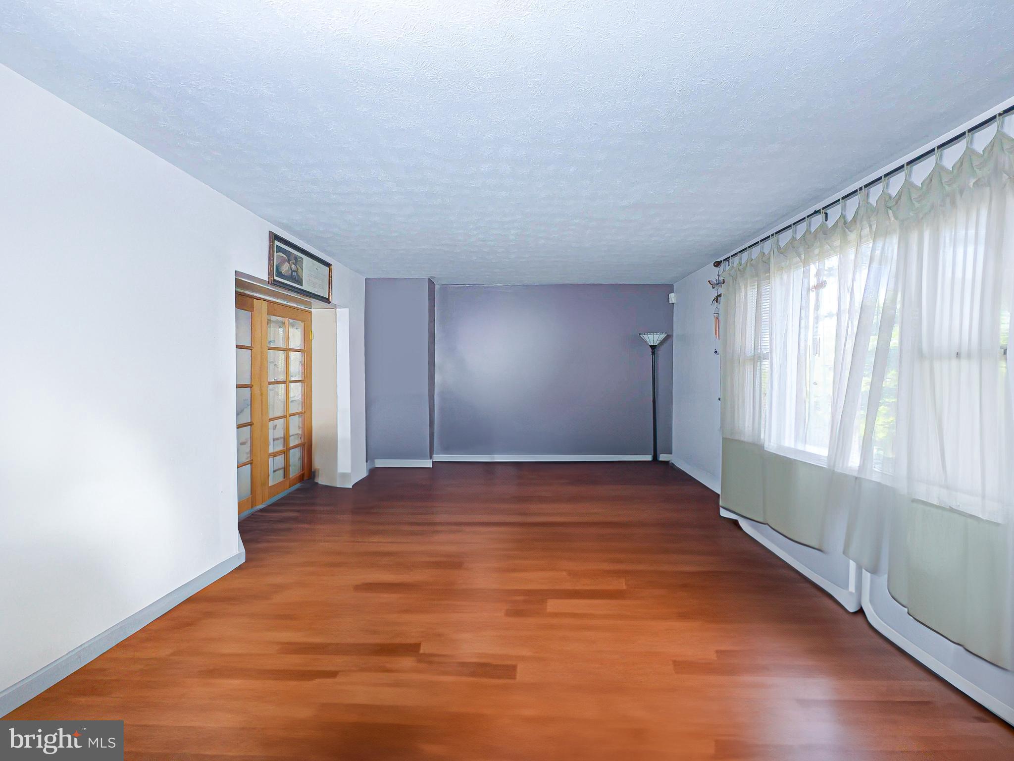 408 44th Street Northeast Washington, DC 20019 - Photo 4 of 13 an empty room with wooden floor and windows