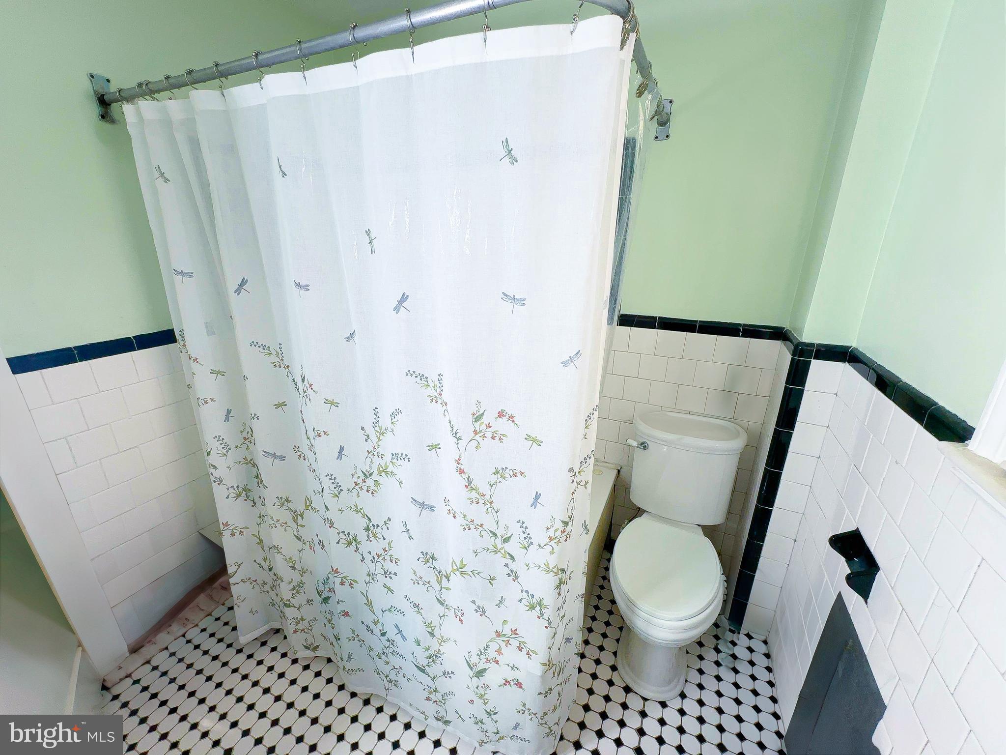 408 44th Street Northeast Washington, DC 20019 - Photo 7 of 13 a bathroom with a toilet and a shower curtain