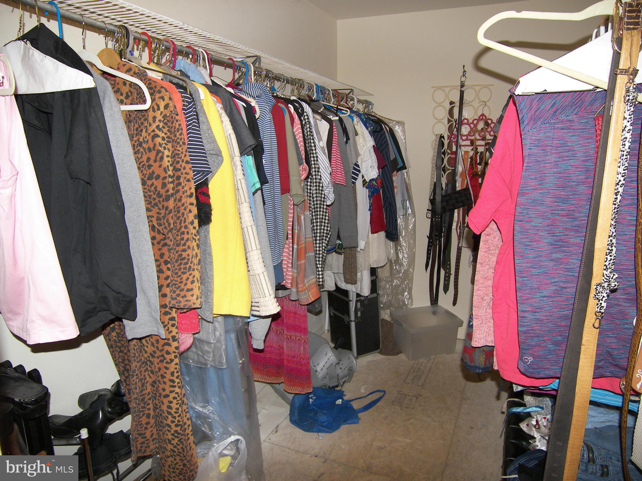 9507 Good Luck Road Lanham, MD 20706 - Photo 14 of 18 a view of walk in closet with clothes and shoes