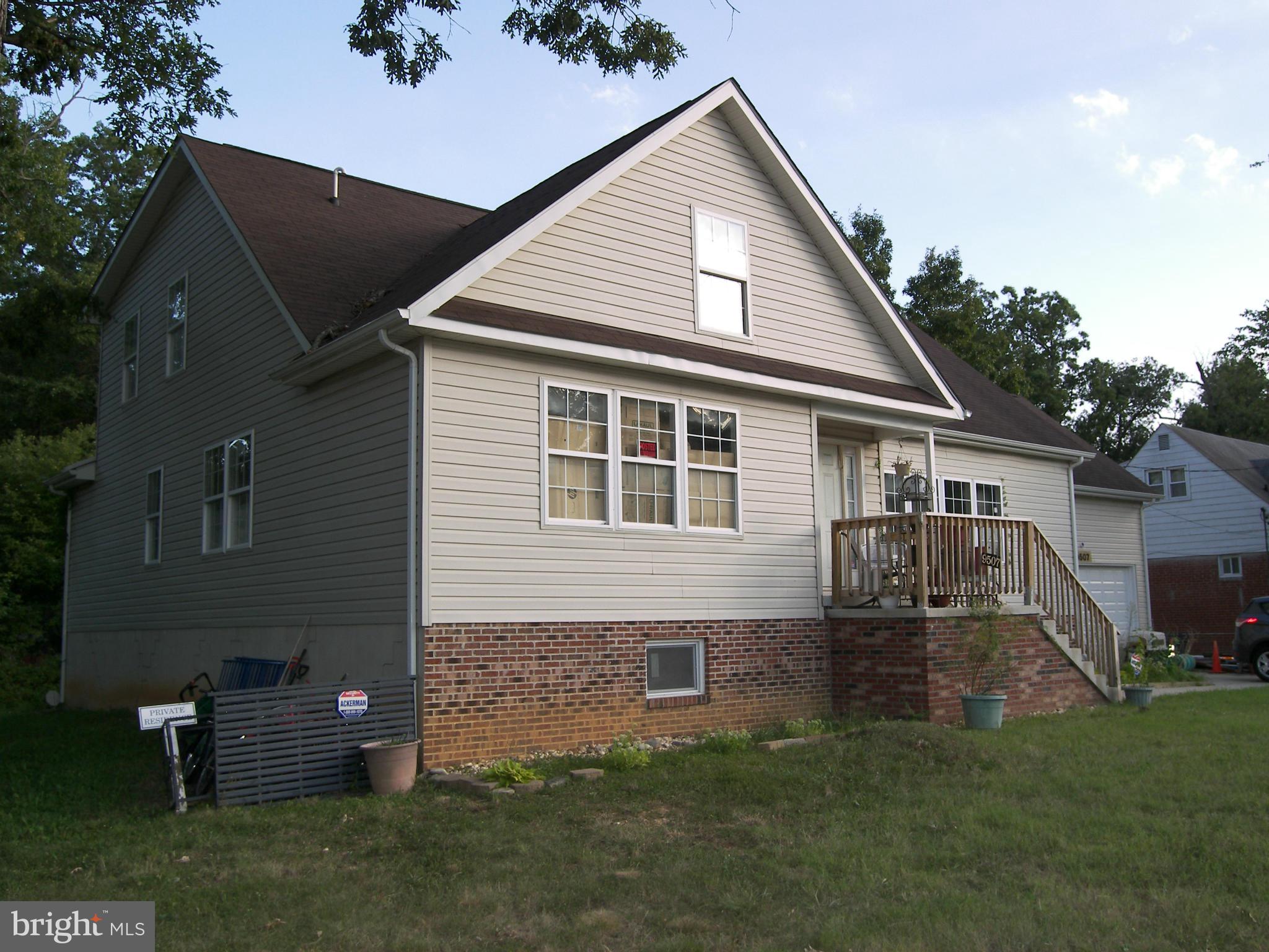 9507 Good Luck Road Lanham, MD 20706 - Photo 3 of 18 a front view of house with a garden