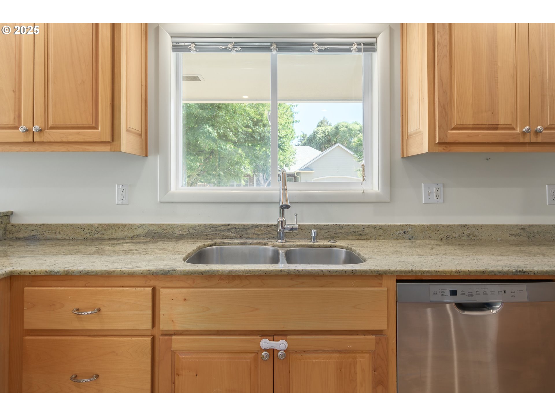 708 Blackstone Street Springfield, OR 97477 - Photo 11 of 45 a kitchen with stainless steel appliances granite countertop wooden cabinets a sink and a window