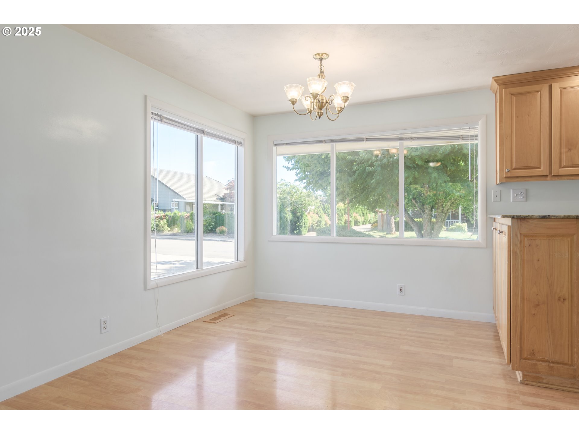 708 Blackstone Street Springfield, OR 97477 - Photo 13 of 45 a view of an empty room with wooden floor and windows