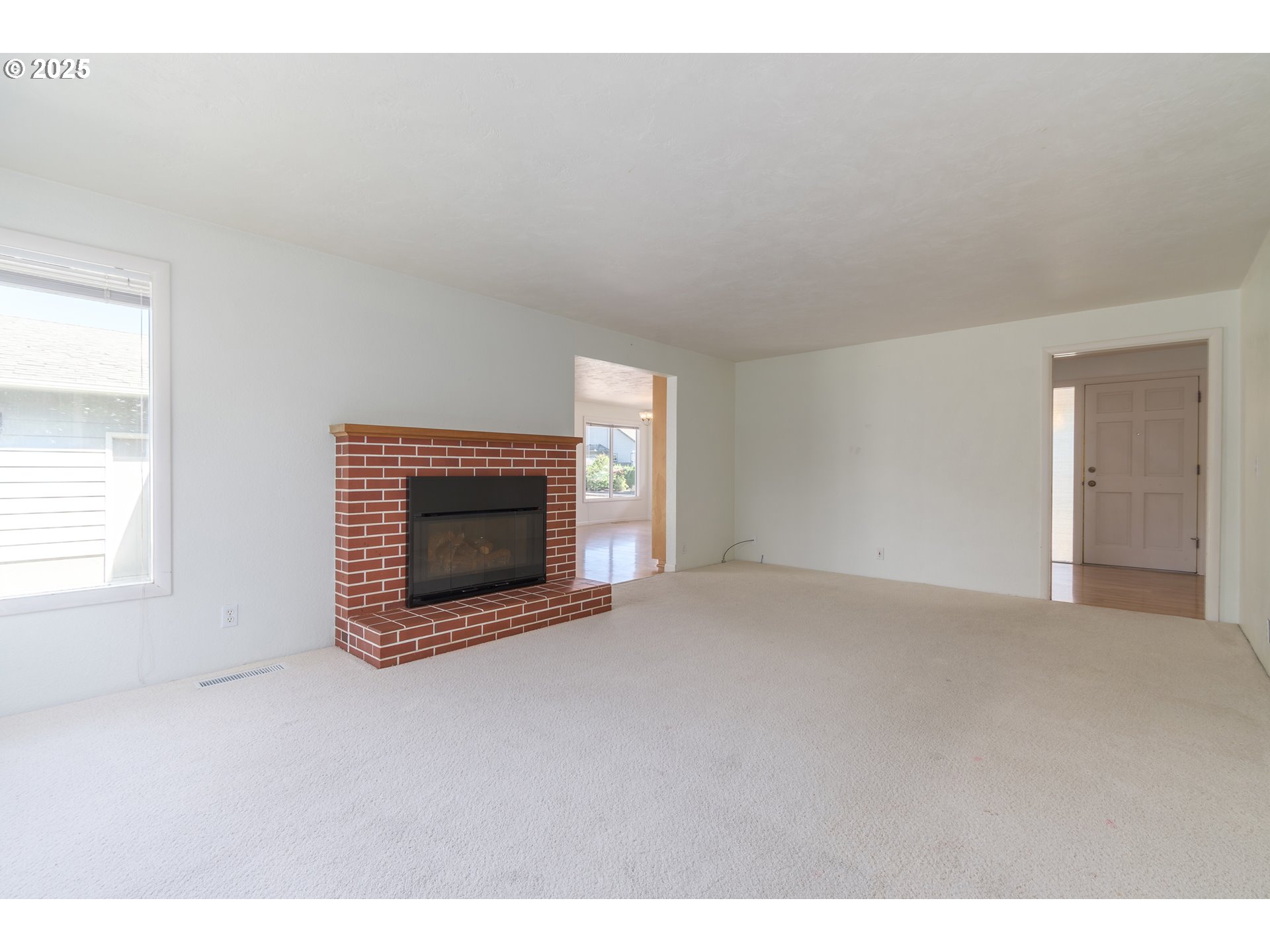 708 Blackstone Street Springfield, OR 97477 - Photo 4 of 45 a view of empty room with a fireplace