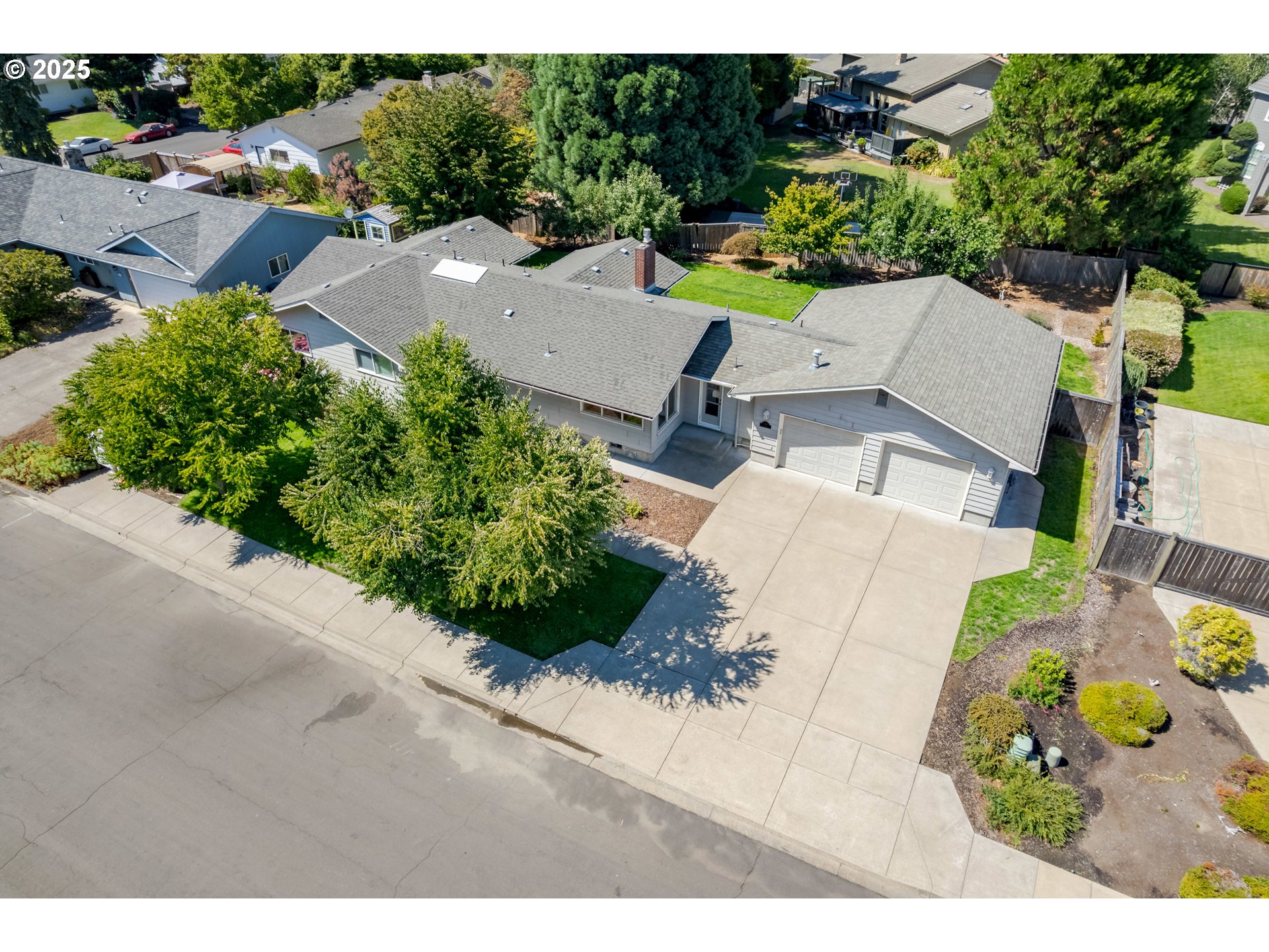 708 Blackstone Street Springfield, OR 97477 - Photo 41 of 45 an aerial view of a house with a yard and greenery