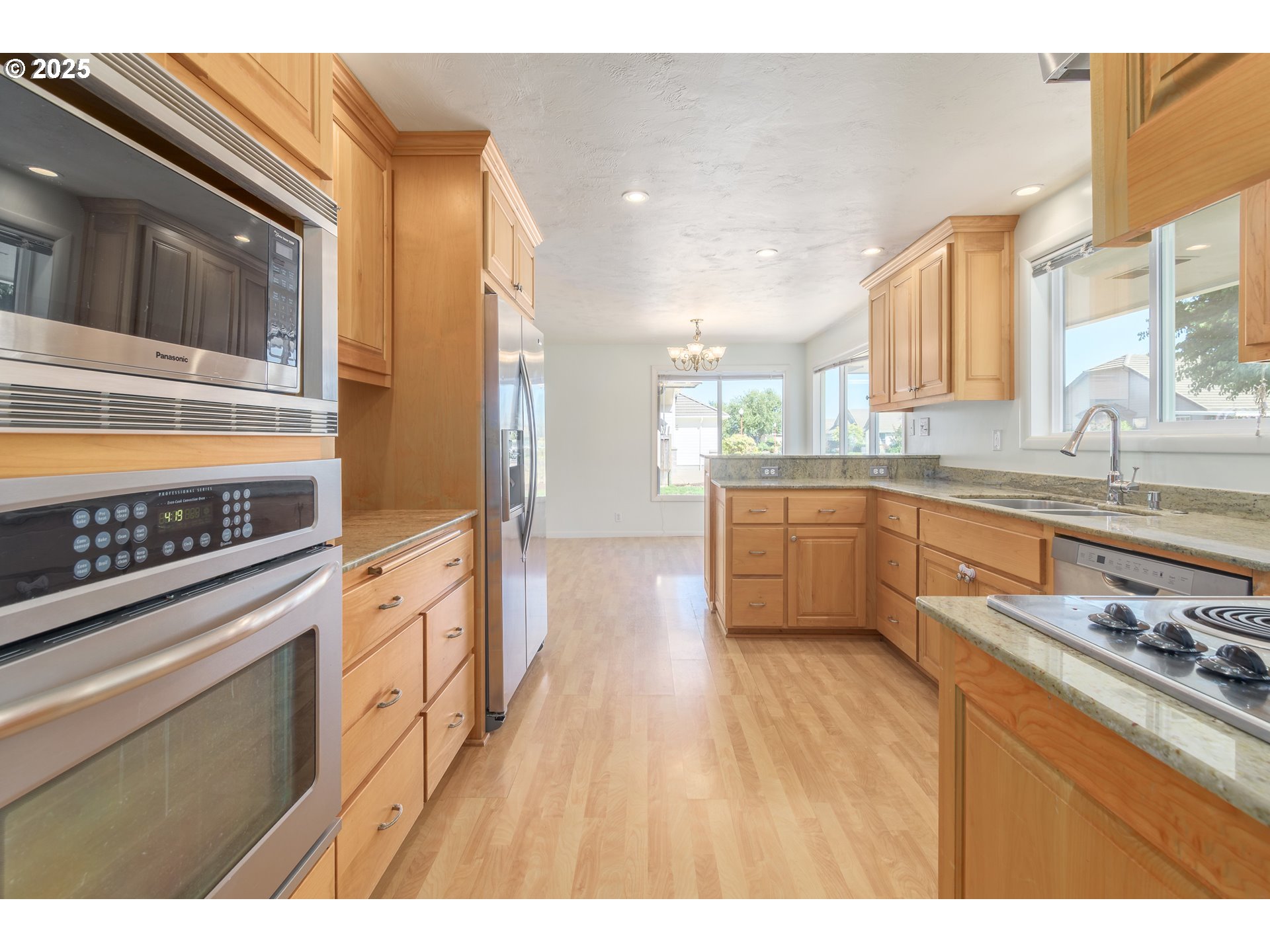 708 Blackstone Street Springfield, OR 97477 - Photo 10 of 45 a kitchen with stainless steel appliances granite countertop a stove and a sink