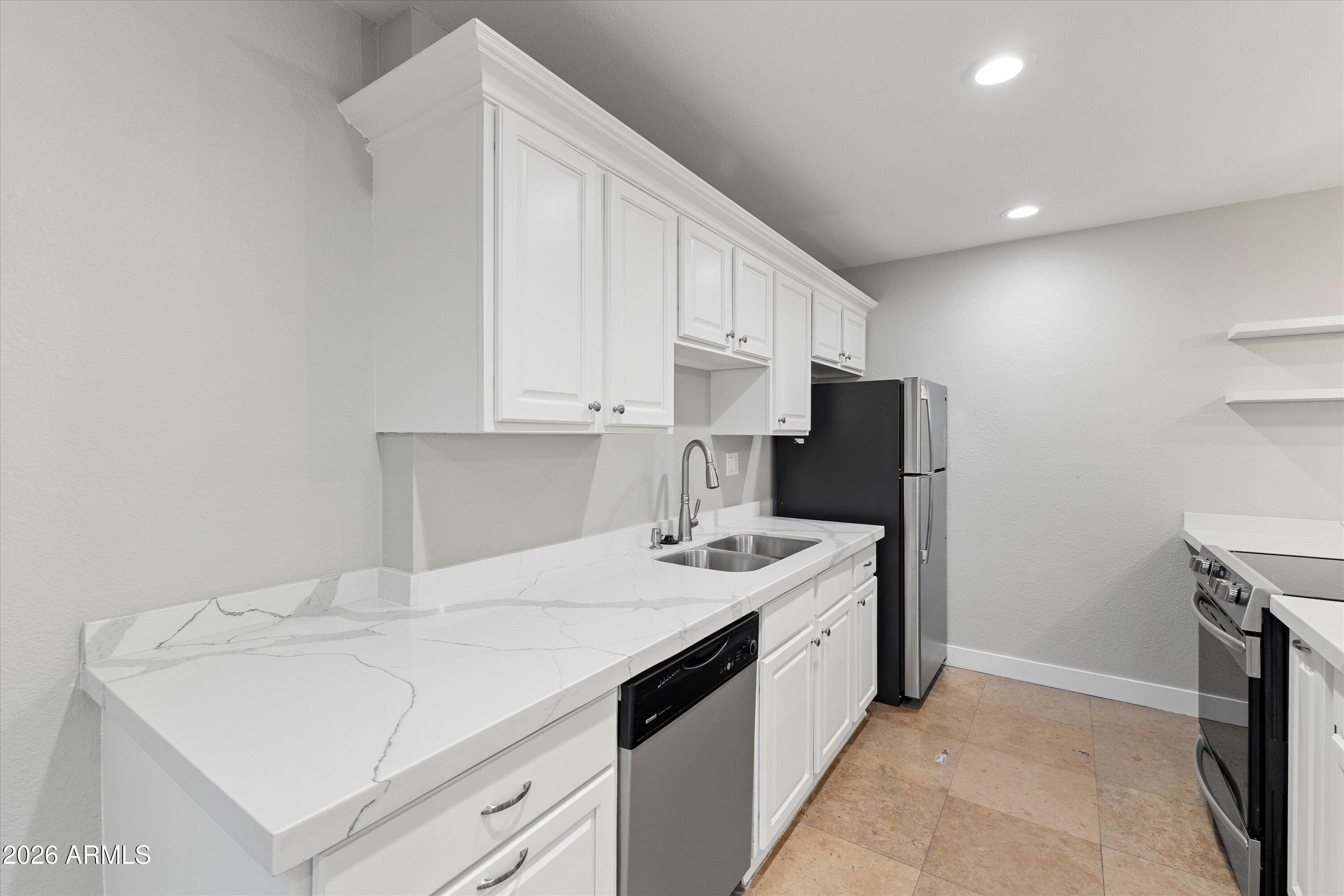 5525 East Thomas Road, Unit L1 Phoenix, AZ 85018 - Photo 12 of 33 a kitchen with a sink a stove and refrigerator