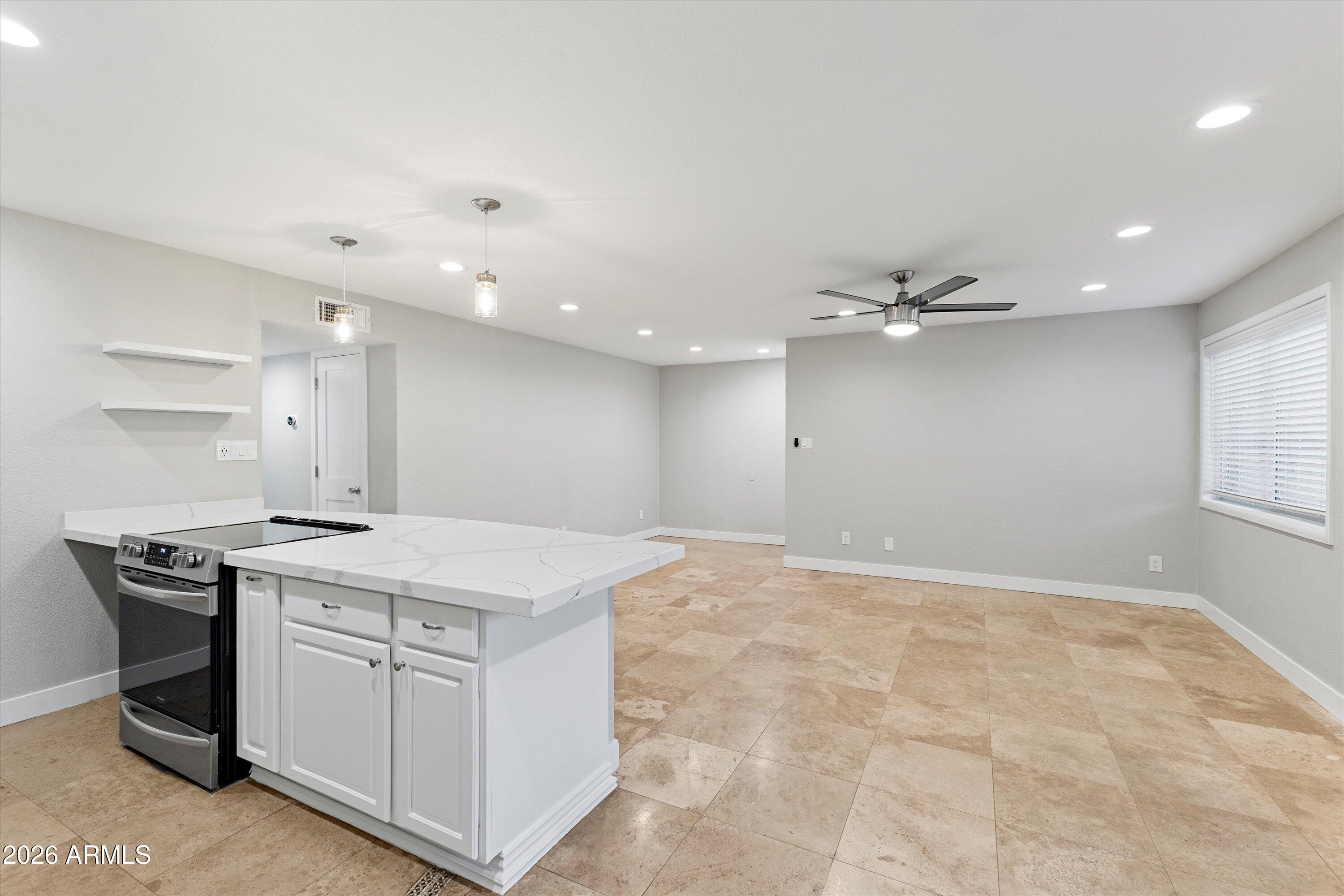 5525 East Thomas Road, Unit L1 Phoenix, AZ 85018 - Photo 13 of 33 a view of a kitchen with a sink and chandelier