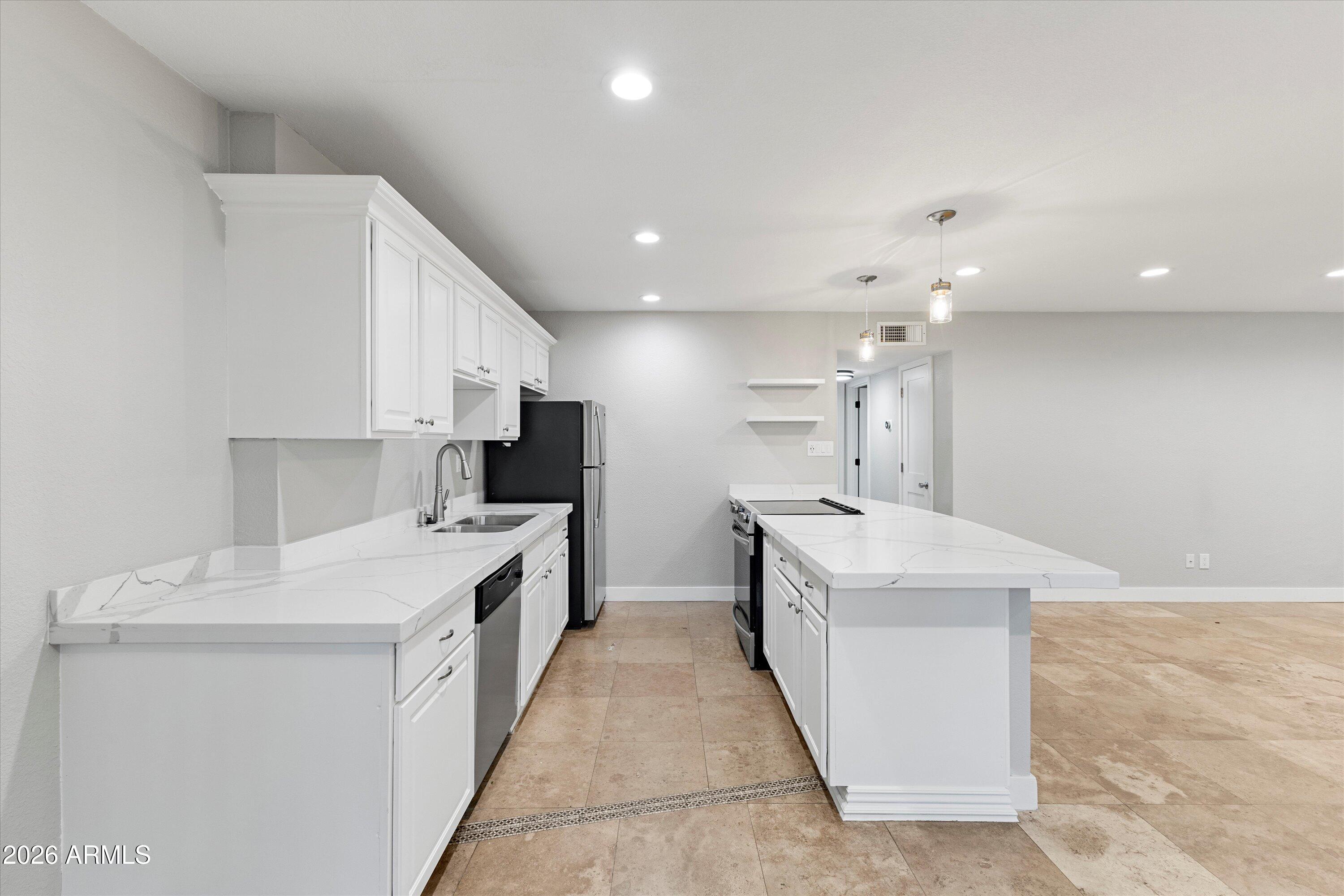 5525 East Thomas Road, Unit L1 Phoenix, AZ 85018 - Photo 14 of 33 a large white kitchen with a stove top oven a sink and dishwasher