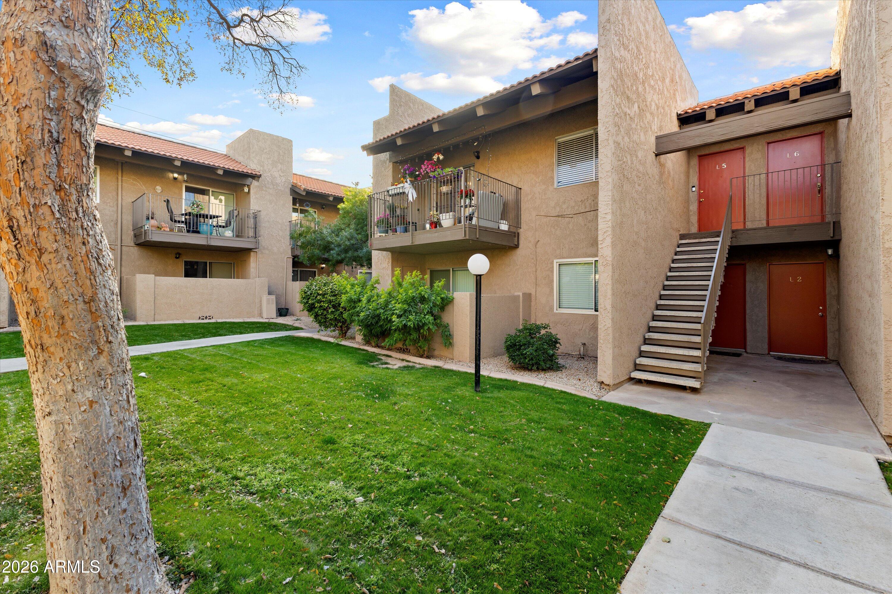 5525 East Thomas Road, Unit L1 Phoenix, AZ 85018 - Photo 2 of 33 a front view of a house with a yard