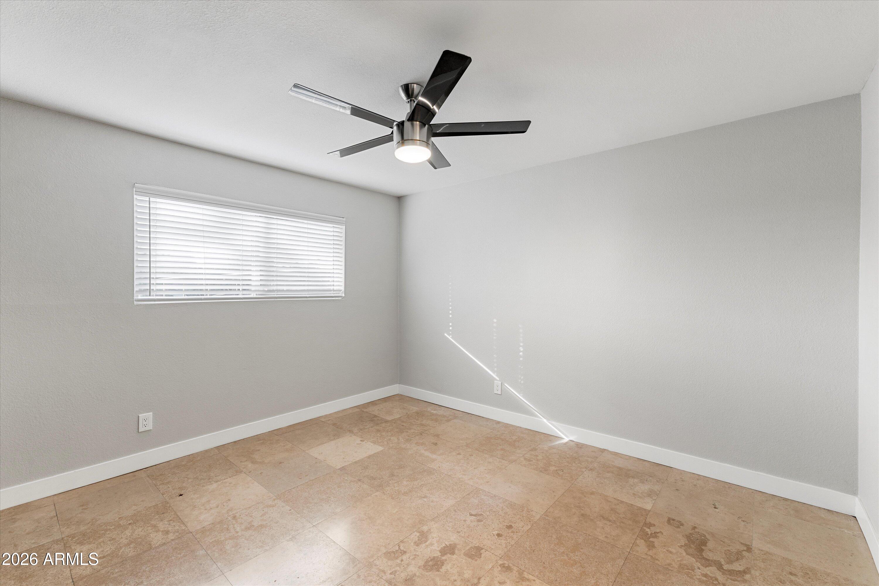 5525 East Thomas Road, Unit L1 Phoenix, AZ 85018 - Photo 26 of 33 an empty room with a window and a fan