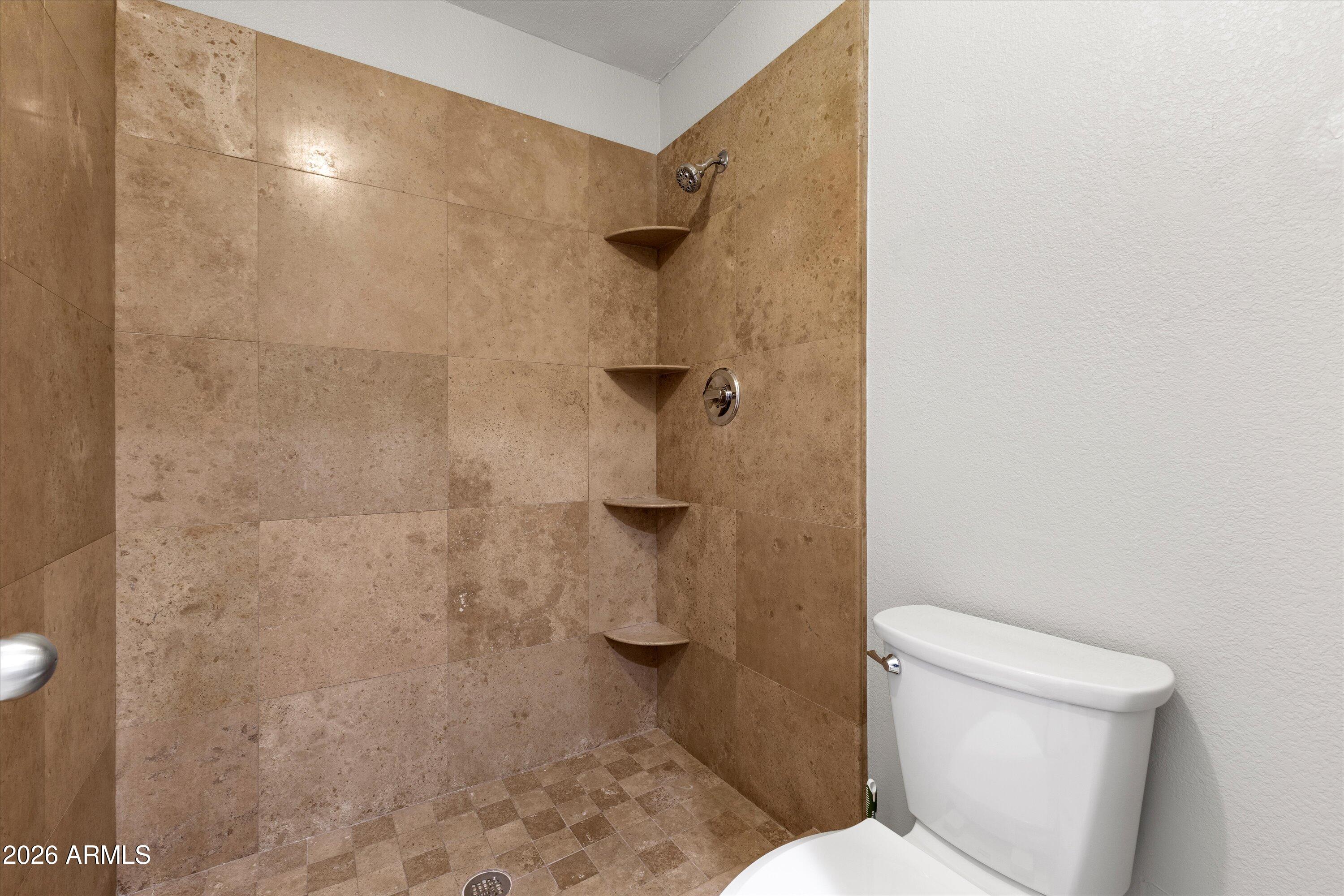 5525 East Thomas Road, Unit L1 Phoenix, AZ 85018 - Photo 31 of 33 a white toilet sitting next to a shower