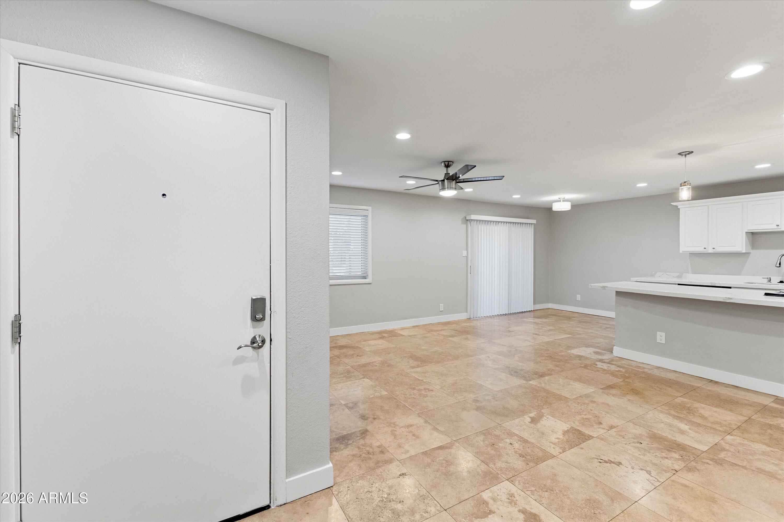 5525 East Thomas Road, Unit L1 Phoenix, AZ 85018 - Photo 4 of 33 a view of an empty room and kitchen view
