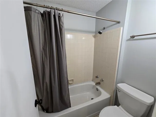 a bathroom with a shower and a toilet