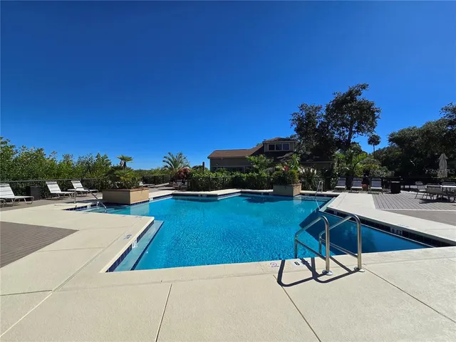 a view of swimming pool with chairs