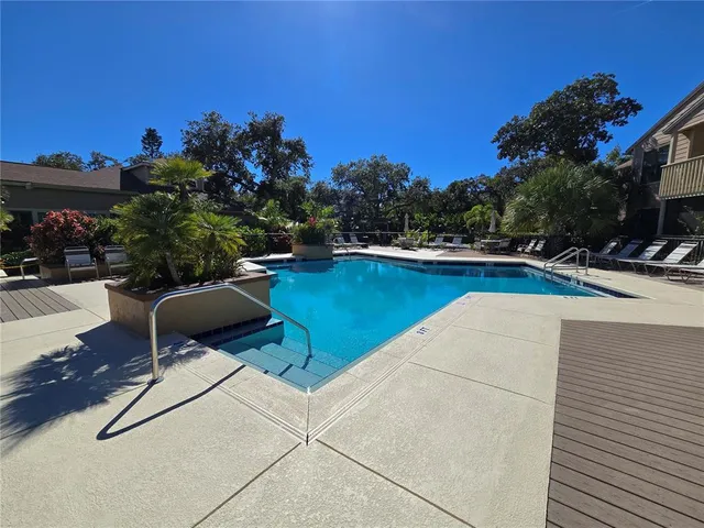 a swimming pool with outdoor seating and yard