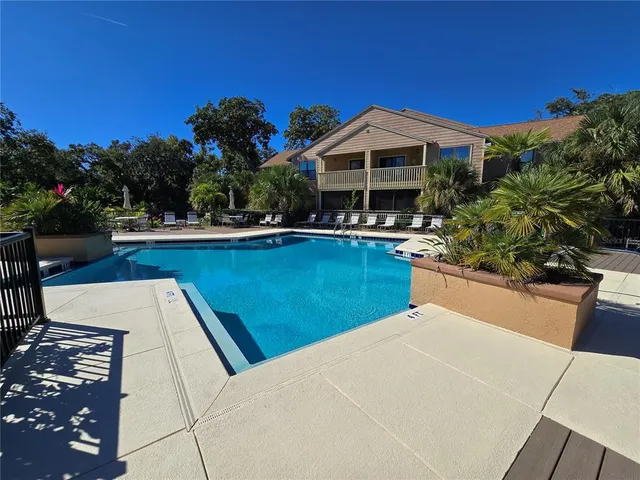 a view of a house with pool fire pit and outdoor seating