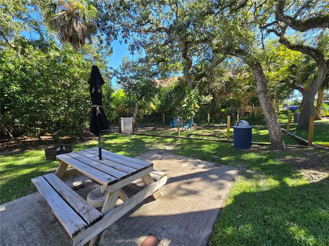 a view of a backyard with a small deck and a fire pit