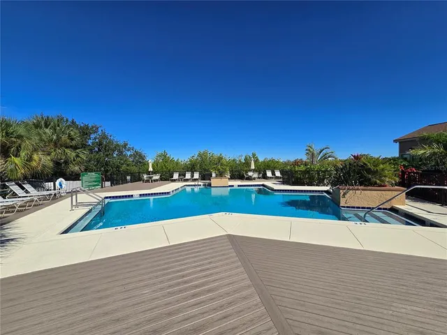 a view of a swimming pool and lounge chair