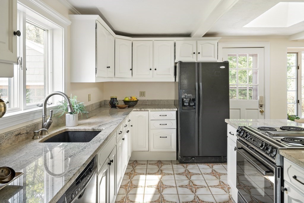 20 Stowell Road Winchester, MA 01890 - Photo 17 of 34 a kitchen with granite countertop a sink stove and refrigerator