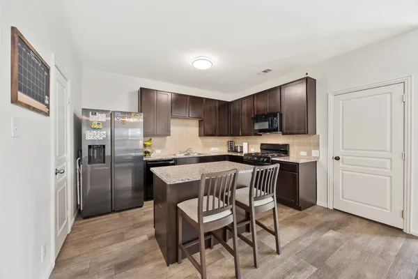 a kitchen with stainless steel appliances a refrigerator stove microwave and cabinets