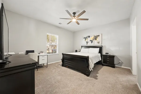 a bedroom with a bed and a desk