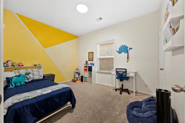 a bedroom with a bed and a workspace