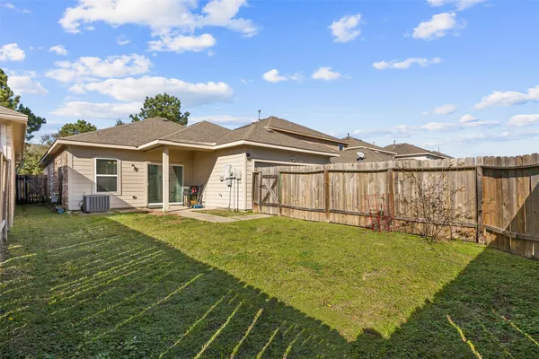 a view of a house with a yard and sitting area