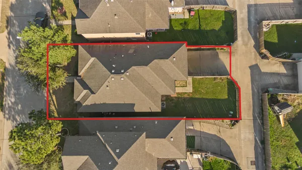 an aerial view of a house with a swimming pool