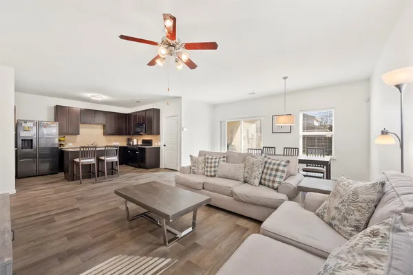 a living room with furniture and kitchen view