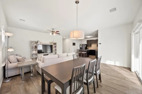a view of a dining room with furniture wooden floor and chandelier